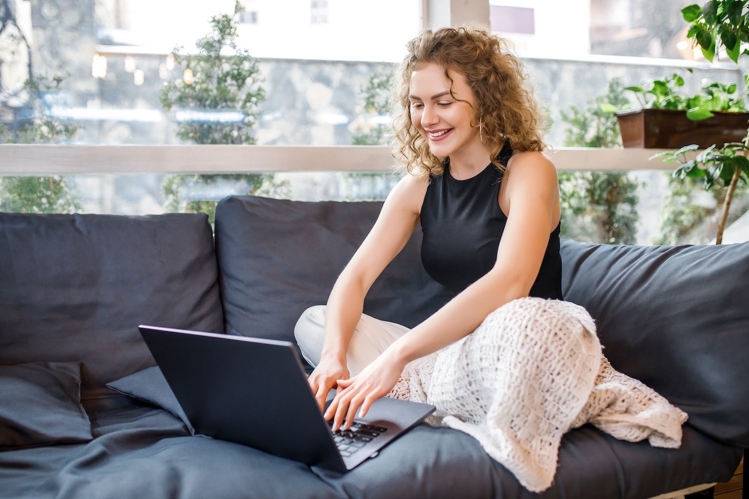 man discussing something with a colleague in front of a laptop