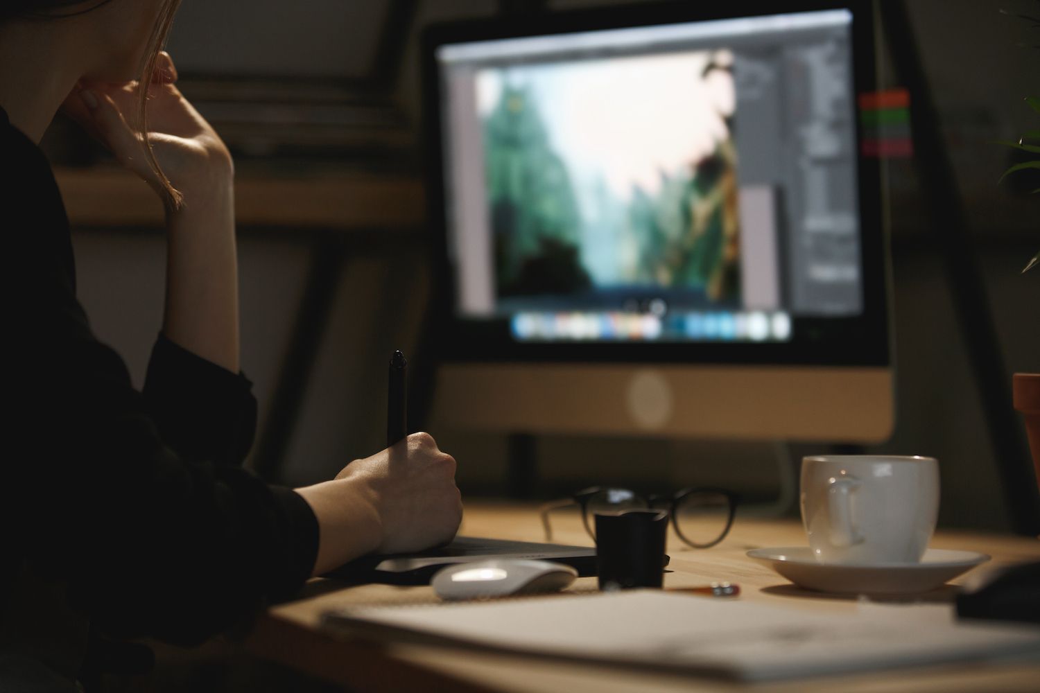 woman writing in a notebook in front of a video course